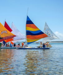 a group of people on small boats in the water